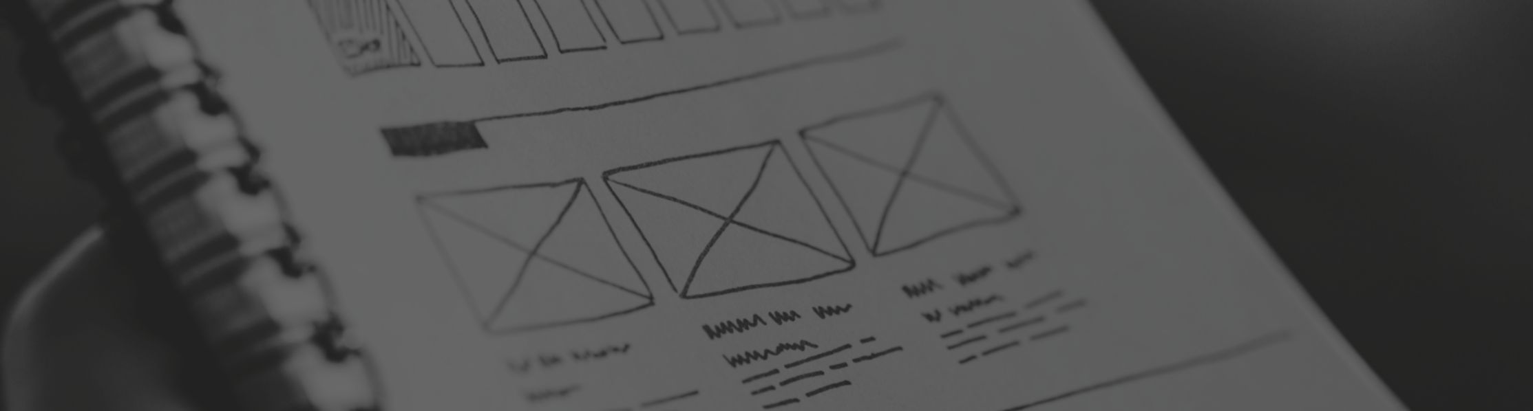 Image showing a website wireframe being sketched on a notepad