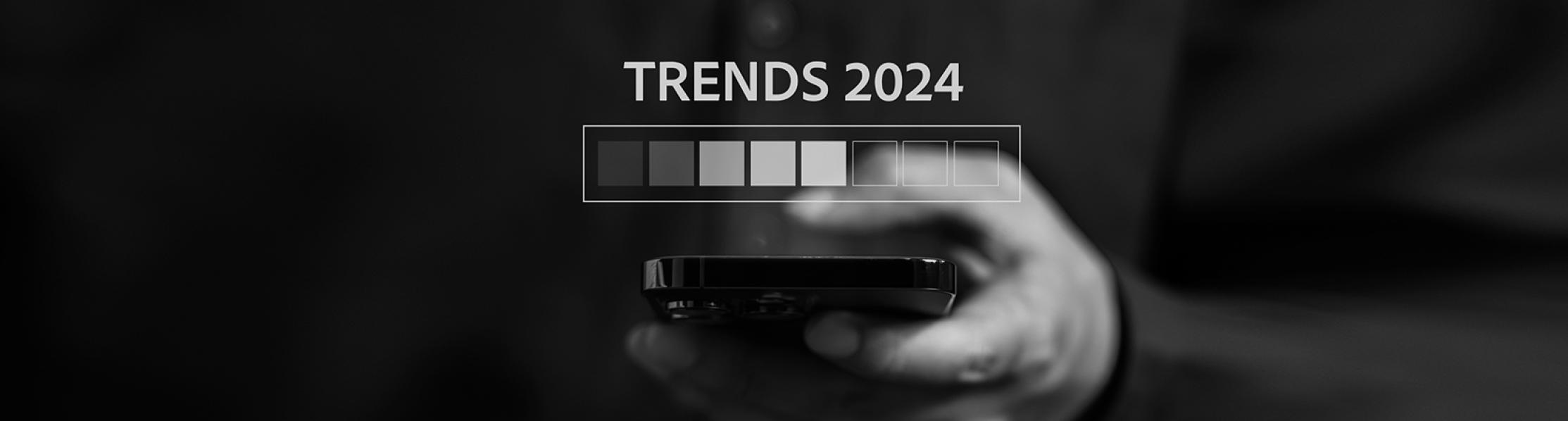 Graphic showing a hand holding a mobile phone with text displaying trends for 2024