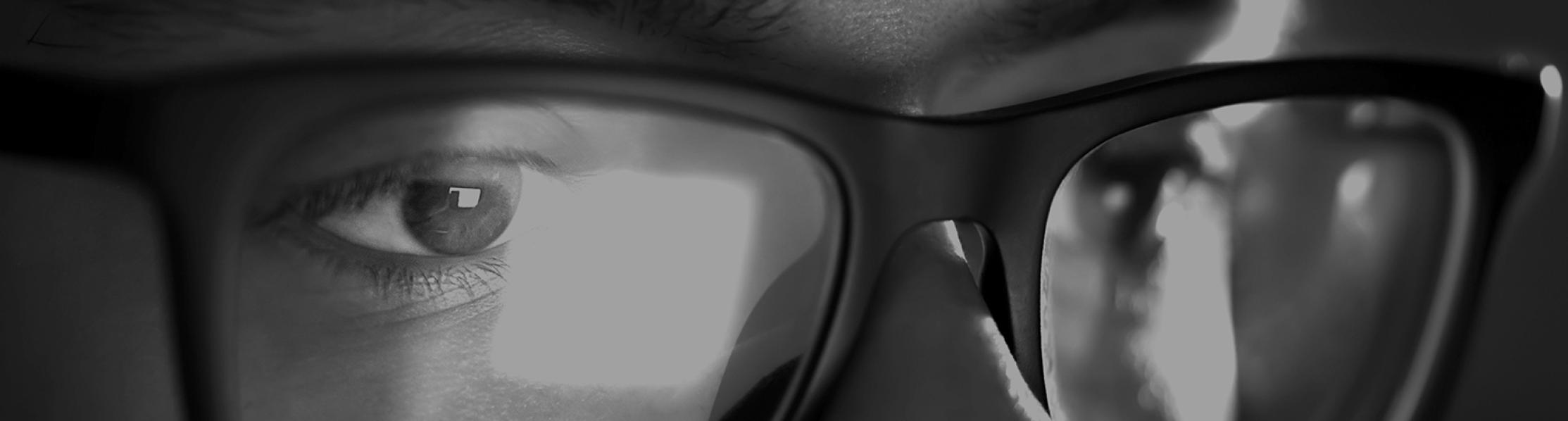Graphic showing a man with glasses looking at a screen 