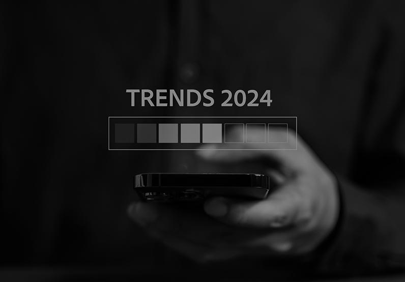 Graphic showing a hand holding a mobile phone with text displaying trends for 2024