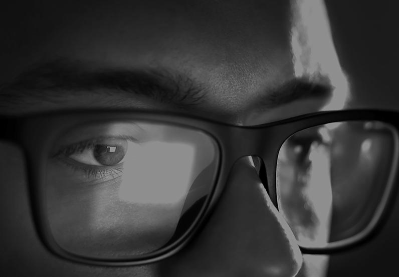 Graphic showing a man with glasses looking at a screen 